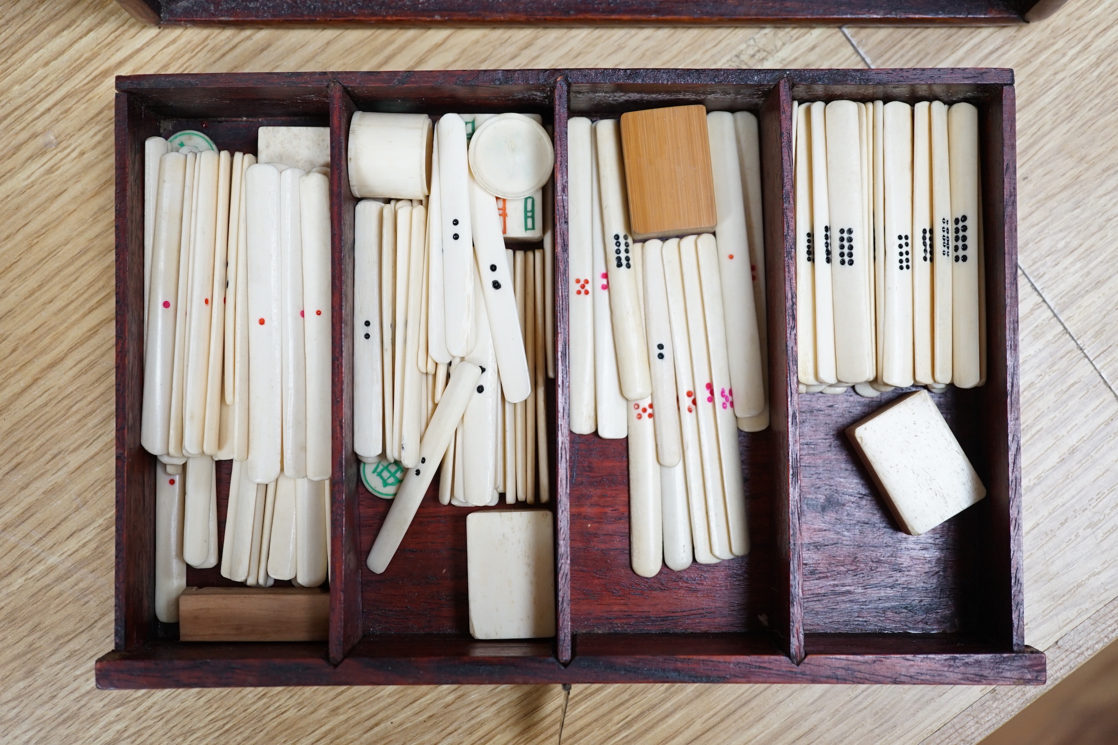 A Chinese Mah-Jong set in hardwood case with bone pieces